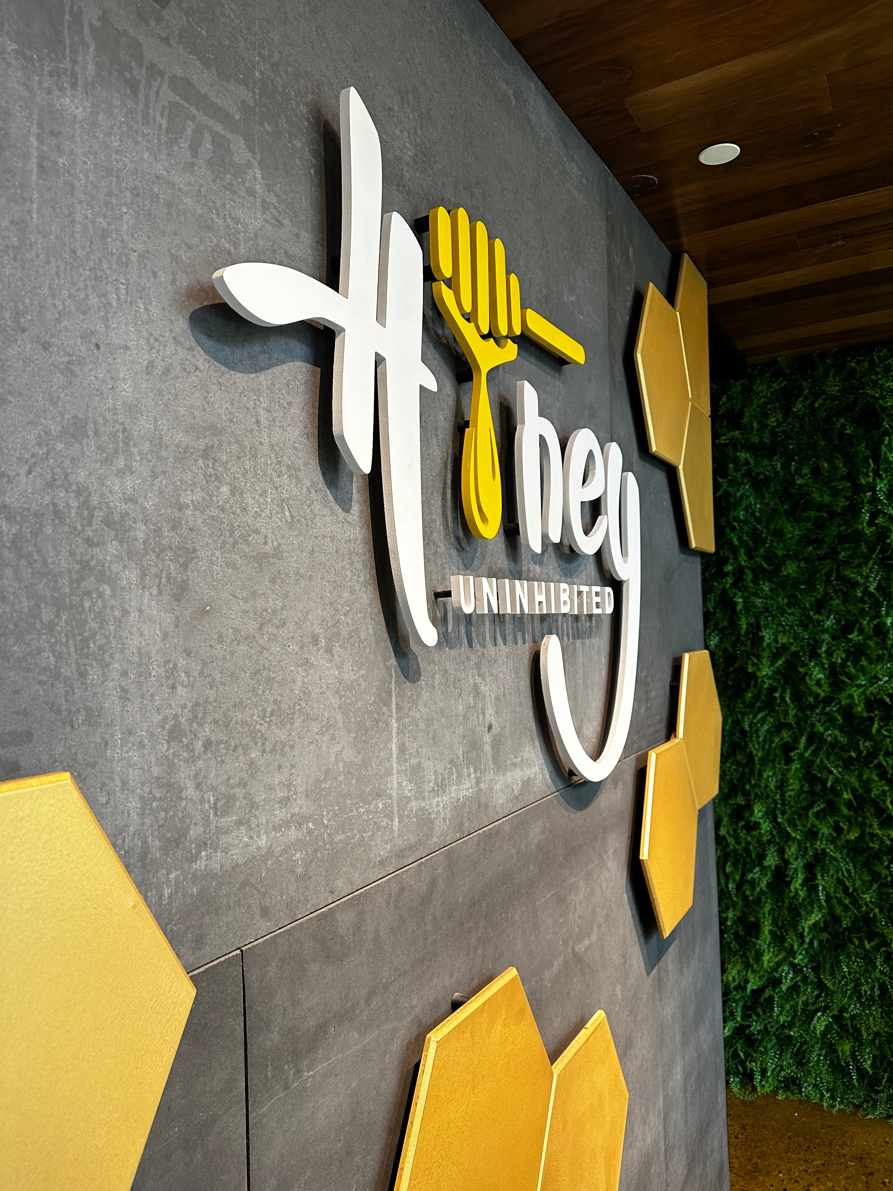 3D logo with text and design elements on a textured surface