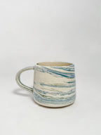 A blue and white marbled stoneware mug 
