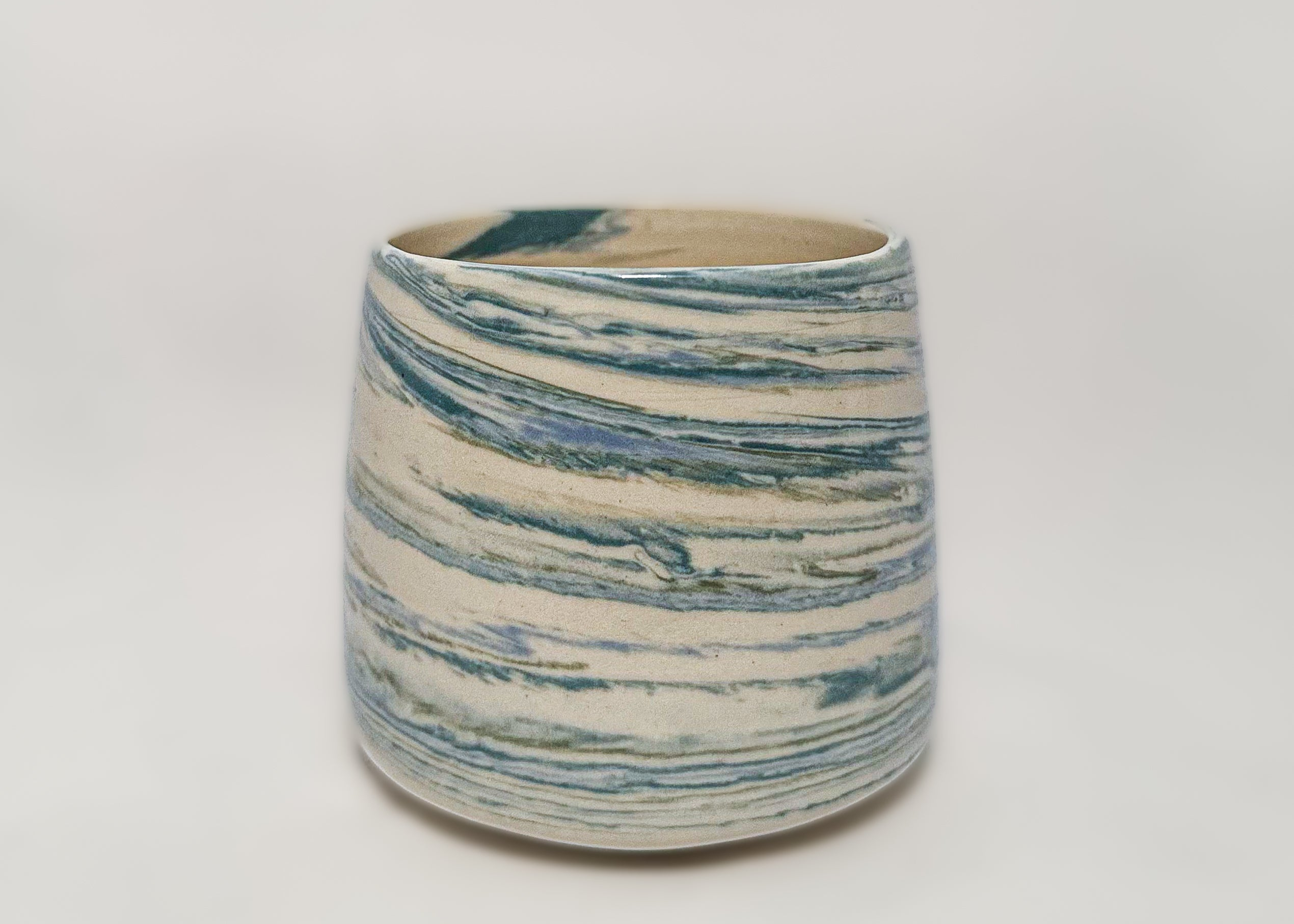 blue and turquoise marbled clay on a white stoneware mug 