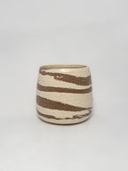 A marbled ceramic stoneware tumbler with brown and white clay